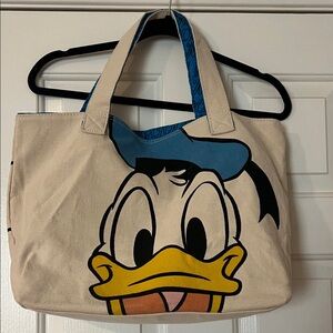 GUC Disneys Donald Duck canvas tote bag. Lined with interior zipper pocket.
